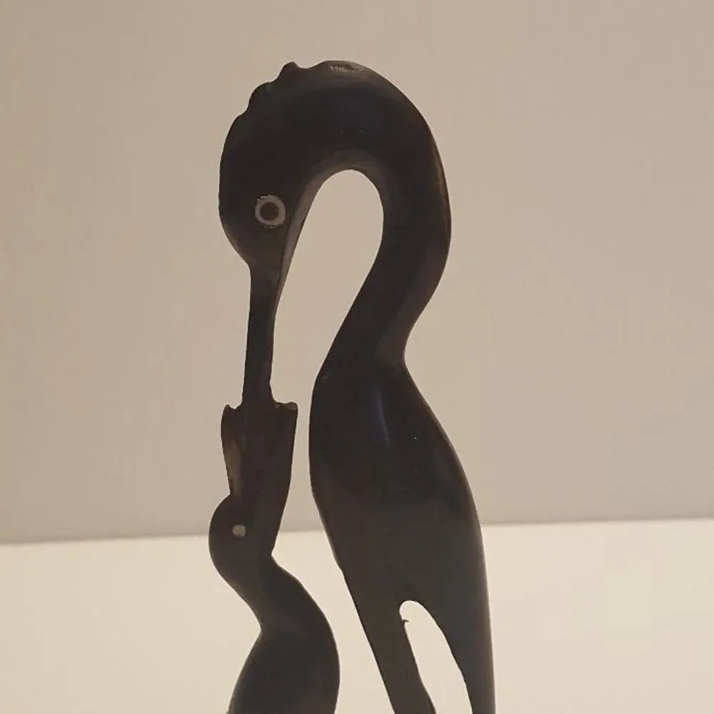 Vintage Stork Bone Figurine feeding a chick. Pre-owned, great shape.